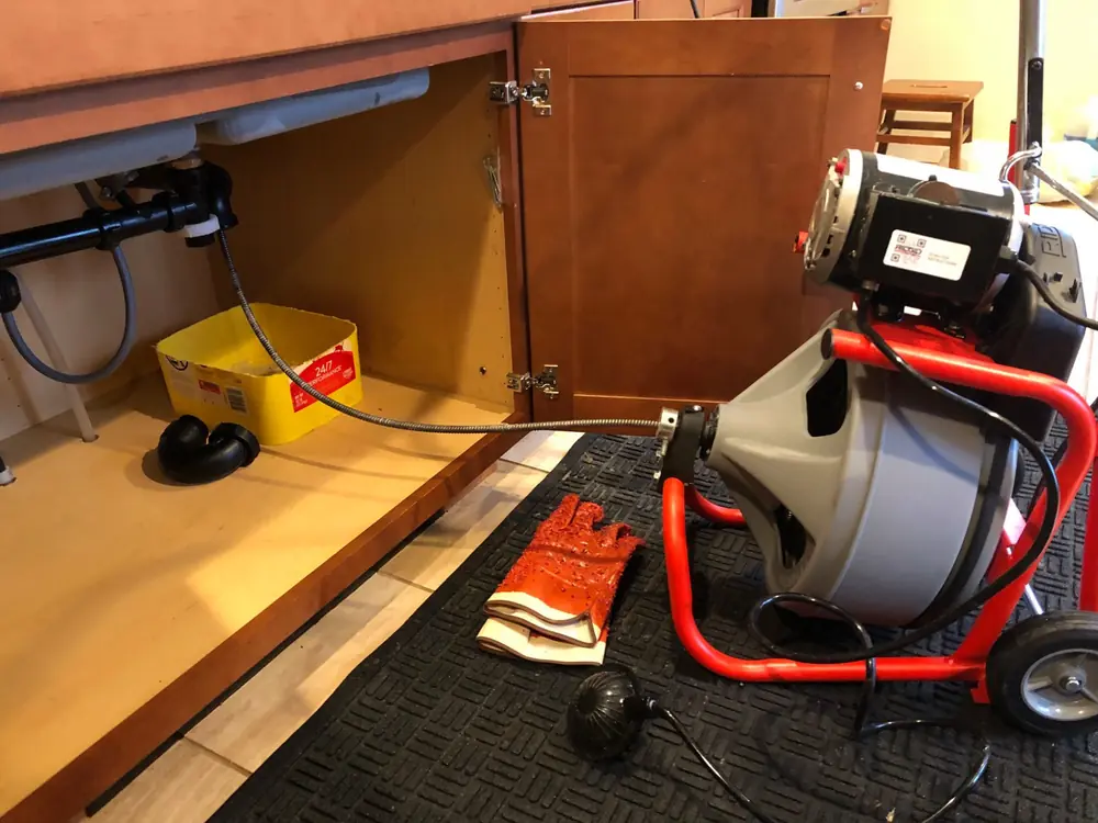 Drainworks drain cleaning machine set up under a kitchen sink